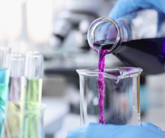 scientist-pouring-pink-chemicals